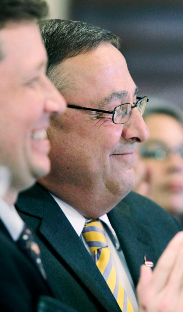 Gov. Paul LePage, right, attends a State House ceremony Wednesday where he signed a bill authorizing the creation of charter schools in Maine. The governor said the schools will offer Maine students greater educational choices. At left is Education Commissioner Stephen Bowen.