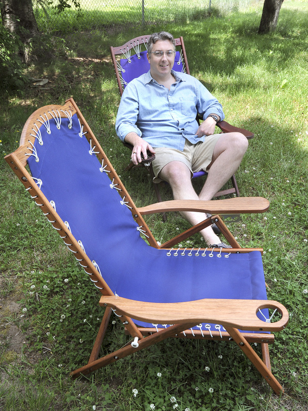 Brian Fish tries out one of his Oh Yeah Comfy beach chairs in his Scarborough yard. He builds the folding chairs made of Brazilian cherry wood and a marine-grade fabric in a workshop at his home. The chairs cost $195 plus shipping.