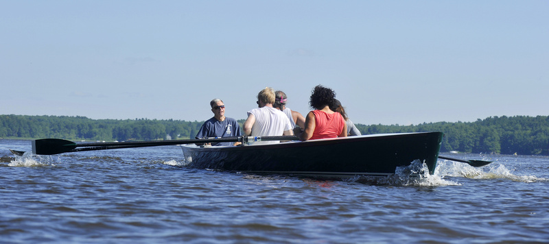 Chuck Mainville, left, and members of his community rowing program on the Kennebec River in Bath during a recent outing. “I get more than I give,” said Mainville.