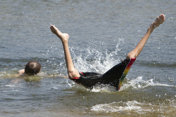 Chase Coro, 14 of Saco, seeks relief from the heat with a plunge into Goosefare Brook in Saco on Friday July 22 , 2011.