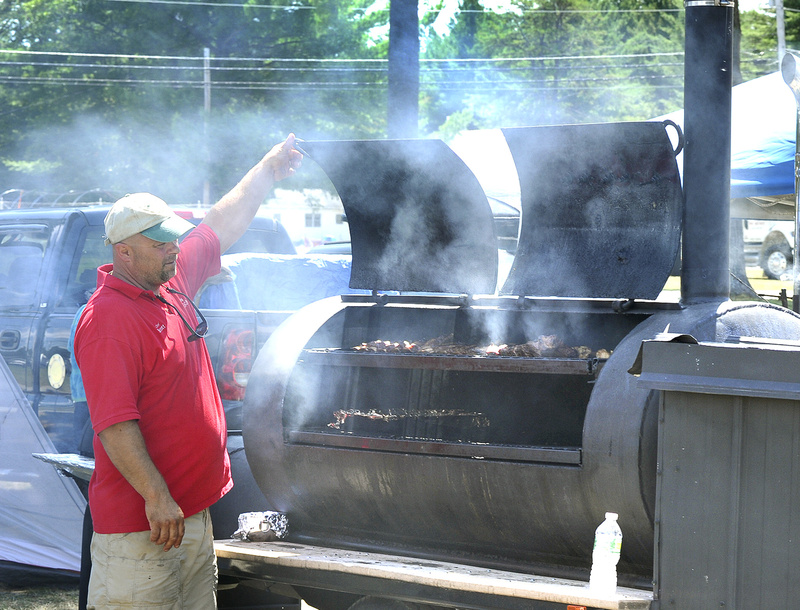Scott Carter from Steep Falls checks on his entries today during the Western Maine BBQ Festival in Fryeburg.