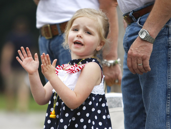 Rylynne Ward, 3, of Bridgton cheers on runners while watching the 4 on the Fourth road race with her grandparents.