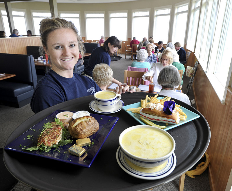 Server Krysten Libby makes a delivery of crab cakes, fish chowder and a lobster roll at the new Dolphin Marina and Restaurant in South Harpswell.