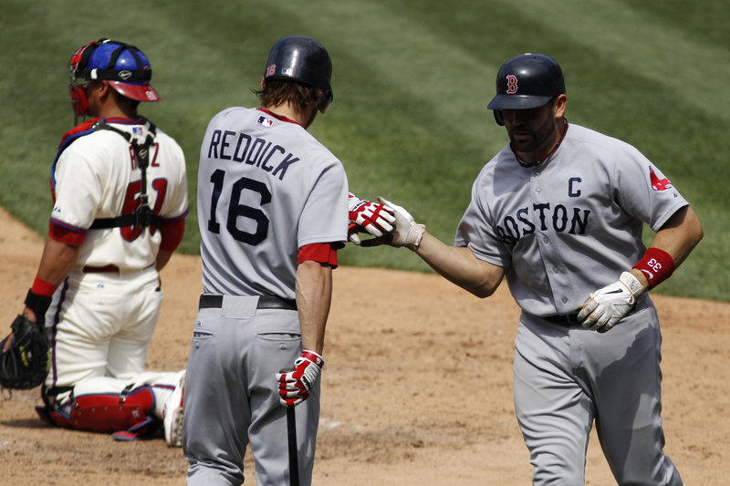Jason Varitek, right, is congratulated by Josh Reddick after hitting a home run in the eighth inning, his second of the game, during Boston’s 5-2 victory Thursday at Philadelphia.