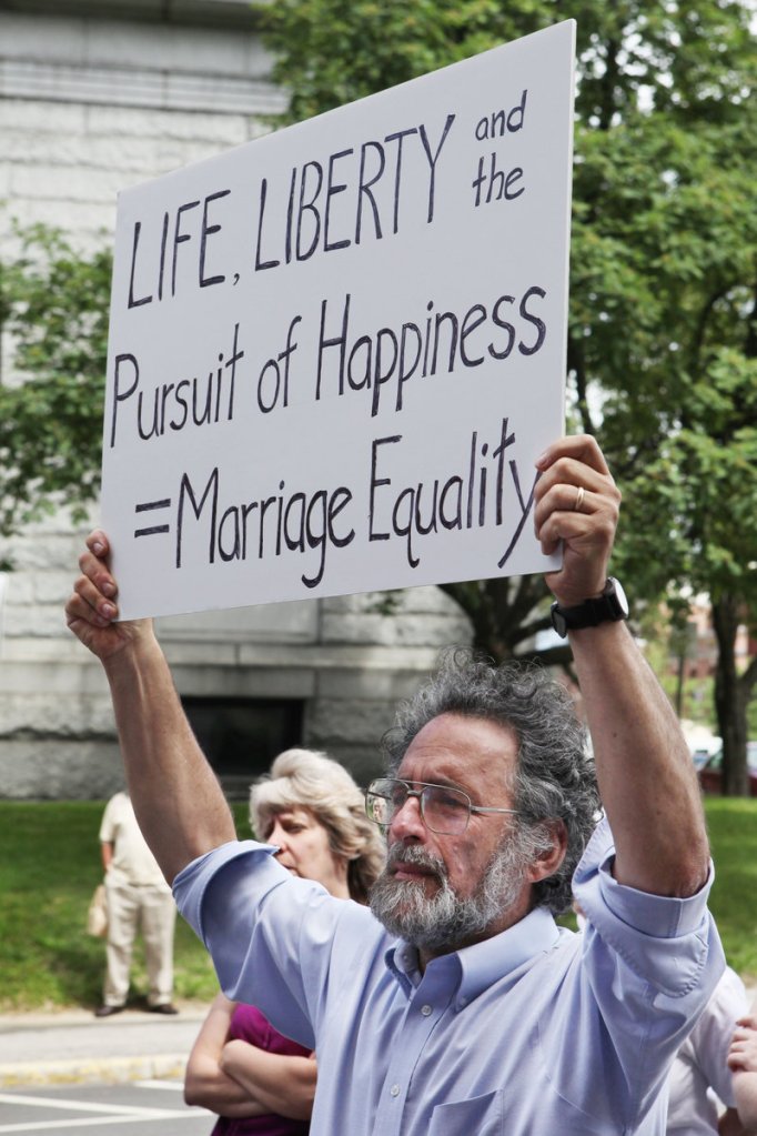 Stan Davis holds a sign supporting same-sex marriage during Thursday's news conference in front of Lewiston City Hall.