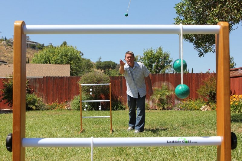 Ladder Golf founder Brent Doud demonstrates his lawn game, also known as ladder toss. Players toss “bolas,” or strings with balls at each end, at three-rung racks, gaining points by hanging the bola or wrapping it around a rung.