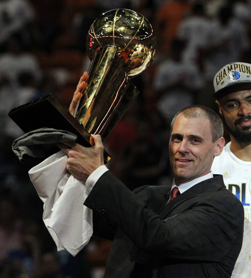 Coach Rick Carlisle holds up the NBA championship trophy after the Dallas Mavericks beat the Miami Heat in last month's finals. Carlisle, who played at Maine for two years before transferring to Virginia, says his experience at Maine has played an important role in his success.