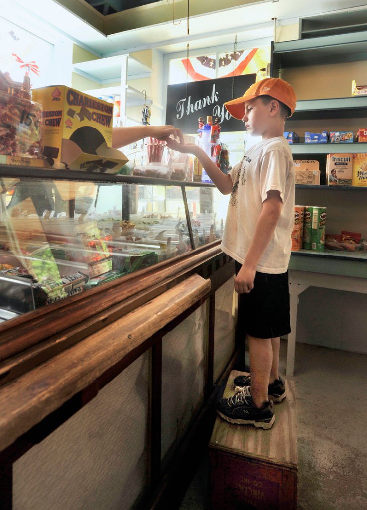 Griffin Foster, 7, of Connecticut pays for his candy.