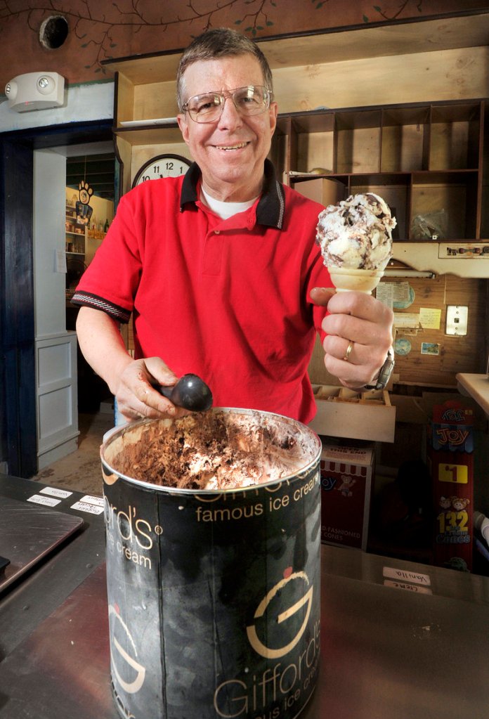 Peter Scontras scoops ice cream for a customer last week. He and his wife, Bridget, are leasing the store.