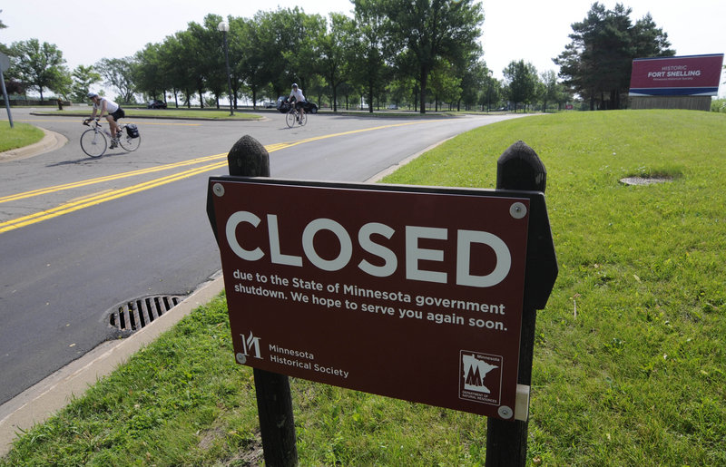 A sign marks the closing of the Fort Snelling historic site Friday in Minneapolis, after state budget talks broke down and the government was forced to shut down at midnight.