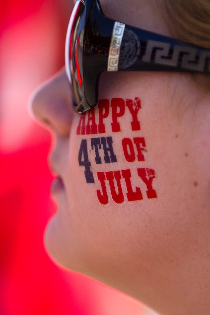 Lauren Blair, 11, of Belton, Texas, shows her patriotism while watching her hometown s Independence Day parade.