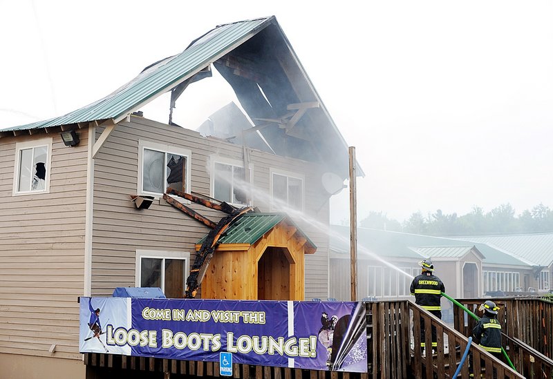 Daryn Slover/Sun Journal Firefighters blast water on a lightning-sparked fire that tore through the main lodge at Mount Abram ski resort in Greenwood on Wednesday. No one was in the lodge when lightning struck.