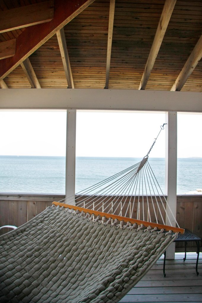 A short wall – instead of a railing – on the wrap-around porch keeps the land out of sight, providing only ocean views for someone relaxing there.