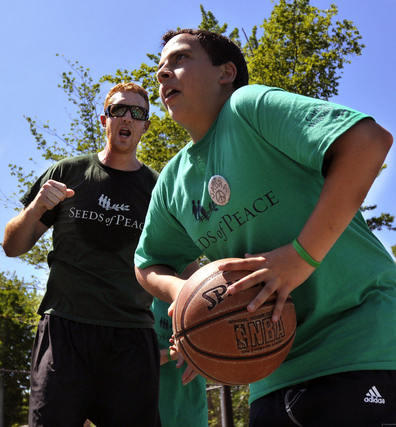 Brian Scalabrine of the Chicago Bulls, and a member of the Boston Celtics' 2008 title team, urges on Jabra, a Seeds of Peace camper from Palestine. Only first names are used for campers because of security concerns in the Middle East.
