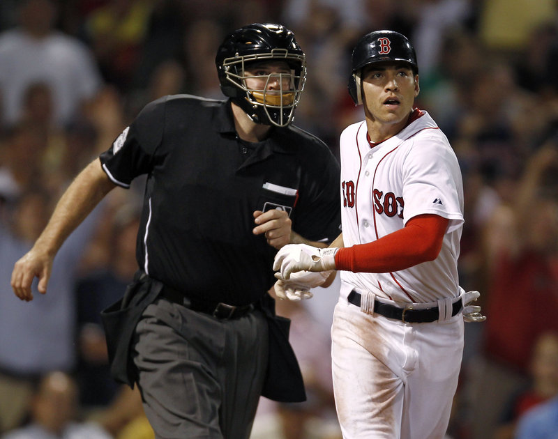 Jacoby Ellsbury is bumped by home plate umpire Bill Welke as they look to see if a ball hit to right field by Ellsbury was fair. The ball stayed fair for Ellsbury’s 11th home run of the season – one of six hit Thursday night by the Red Sox.