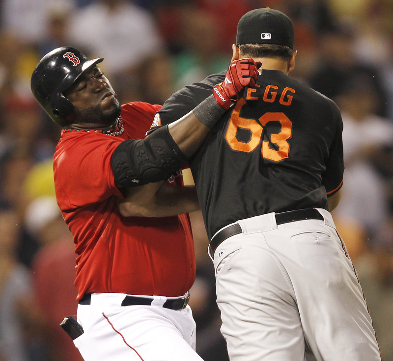 David Ortiz gets in a tussle with Baltimore pitcher Kevin Gregg during Boston’s 10-3 win Friday night at Fenway Park.