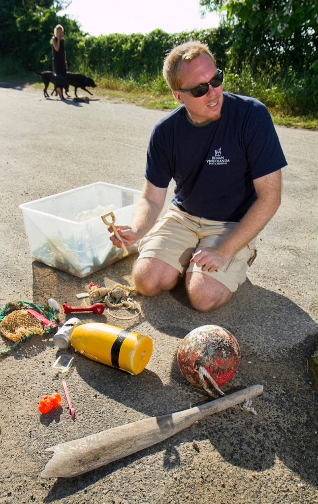 Harold Johnson of Saco displays some of the debris he has collected on Bay View Beach in Saco. Most of what he finds during his weekly cleanup is made of plastic.