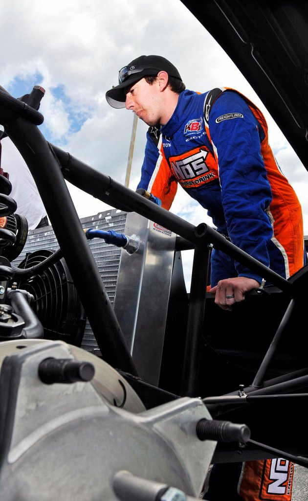 Kyle Busch takes a look Thursday at the car that he will drive July 24 in his third attempt to win the TD Bank 250.