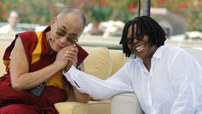 The Dalai Lama holds the hand of actress Whoopi Goldberg during the World Peace event last Saturday at the U.S. Capitol.