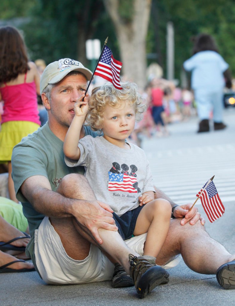 Walter Russell Jr. and his 3-year-old son, Walter Russell III, of North Yarmouth, were among the thousands who watched the Yarmouth Clam Festival’s annual parade Friday evening.