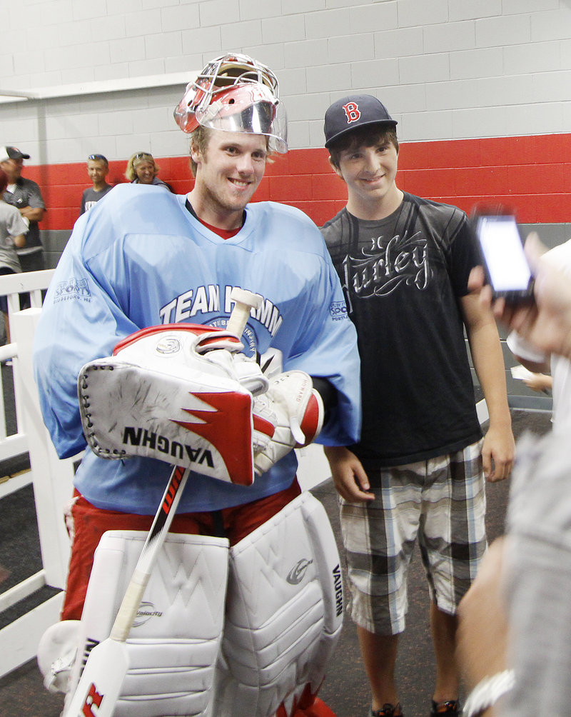 Former UMaine and current Detroit Red Wings goalie Jimmy Howard, left, and Brunswick High goalie Jason Blier were among the 40 players who attended a fundraiser for brain injury-related research Sunday.