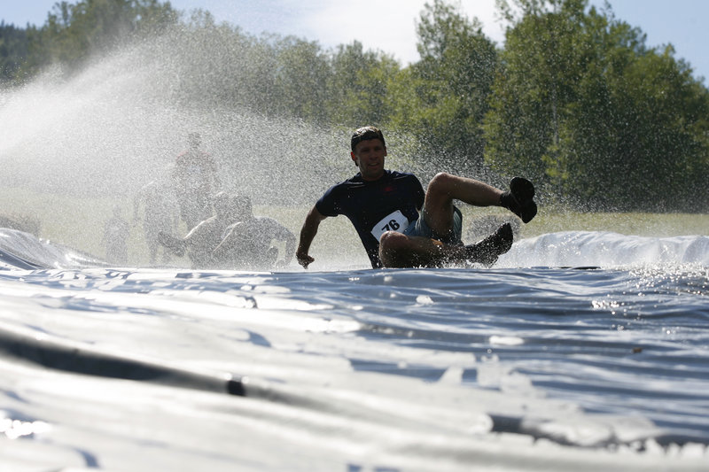 The Slip, Slide & Die obstacle gives competitors a fast ride into a muddy pit.