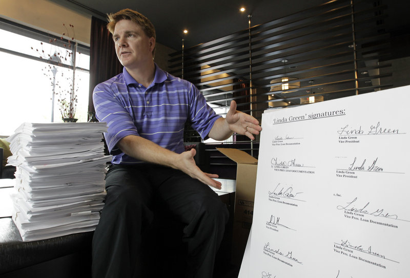 Jeff Thigpen, registrar of deeds in Guilford County, N.C., displays a group of signatures on loan documents all “signed” by Linda Green. The office received 456 documents with suspect signatures from Oct. 1, 2010 through June 30.