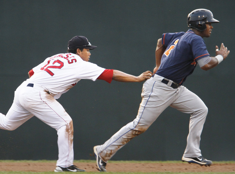 Shortstop Heiker Meneses tags out Binghamton's Raul Reyes, who tried to advance to third on a ground ball in the second inning Monday night at Hadlock Field.