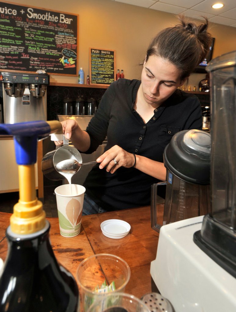 Barista Katherine McWilliams prepares a latte. Massages, aromatherapy, stone work and other stress relievers are offered, too.