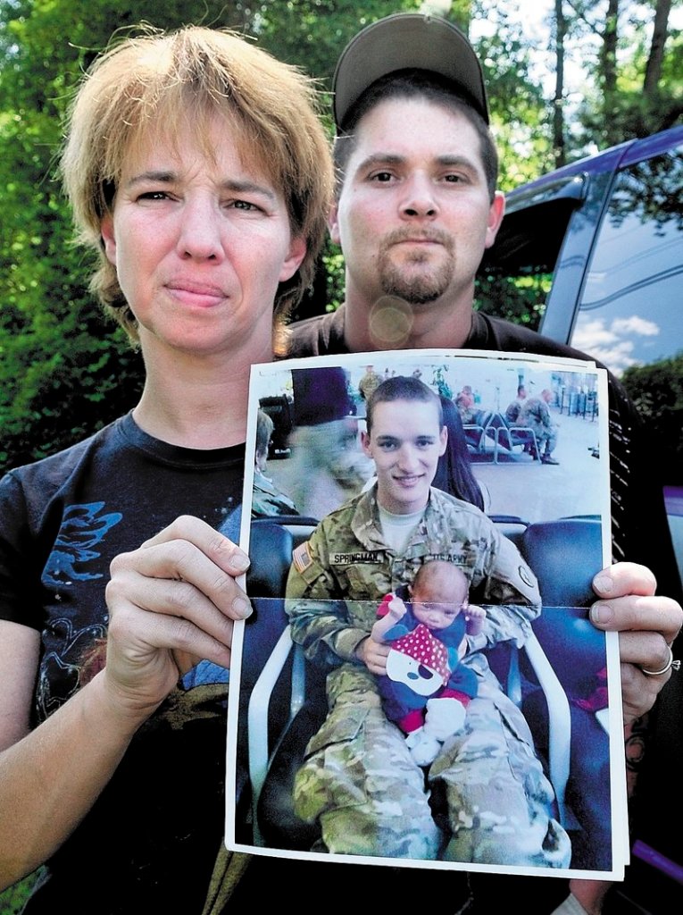 Tina Stratton holds a photograph of her son Pfc. Tyler M. Springmann, who was killed Sunday while serving in Afghanistan. At right is Stratton’s husband, Ben Martin.