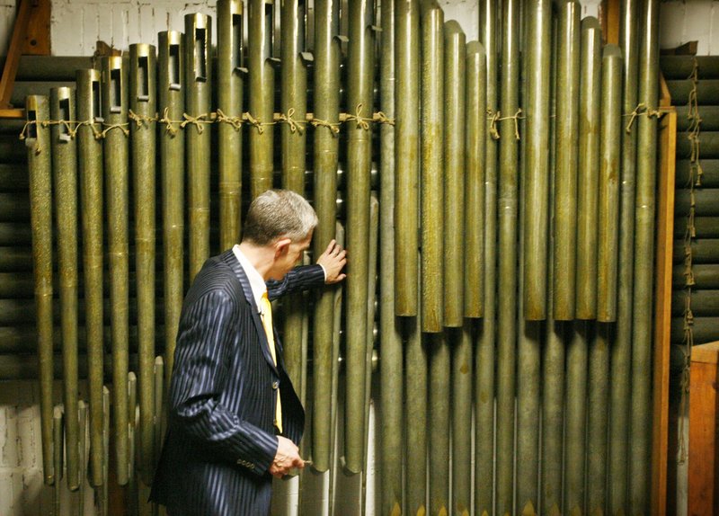 Ray Cornils, Portland’s municipal organist, inspects the Kotzschmar organ, which has been housed in Portland City Hall’s auditorium since 1912. It will remain in use up to its 100th anniversary on Aug. 22, 2012.