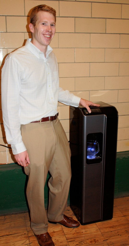Brandon Pollock, one of the founders of Blue Reserve, shows off one of the company's water coolers, an alternative to buying bottled water.
