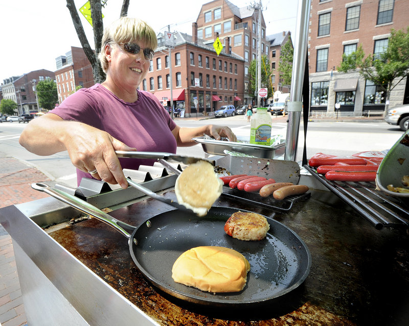 Jill Bourgeois sells lobster cakes and hot dogs from her cart on Commercial Street in Portland. There are 20 licensed food carts in Portland this year, with a wide variety of offerings – from spring rolls to falafel and shish kabob.