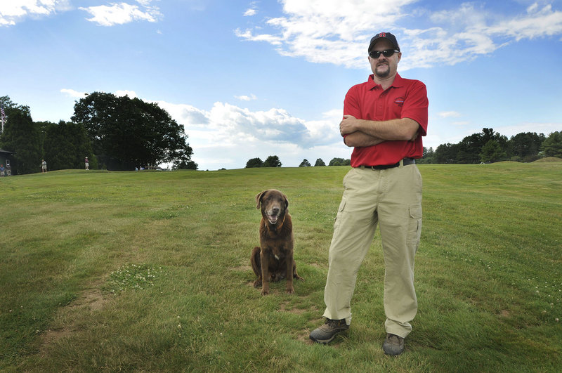 Brendan Parkhurst of Cape Arundel Golf Club in Kennebunkport with his dog Moose on the 18th tee. Parkhurst, superintendent of the golf course for 10 years, majored in turf grass science at Penn State.