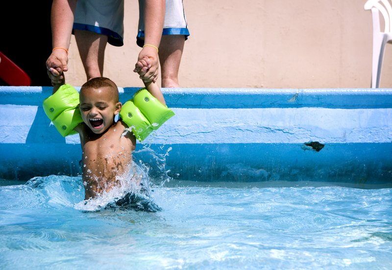 Logan Leadman, 3, of Flushing, Mich., laughs as his older brother Dustin, 19, dips him into the Tucker Memorial Pool in Flushing as temperatures reached the 90s there Wednesday. A heat wave is smothering a large swath of the U.S. with heat index readings (measuring temperature combined with humidity) well over 100 in many places.