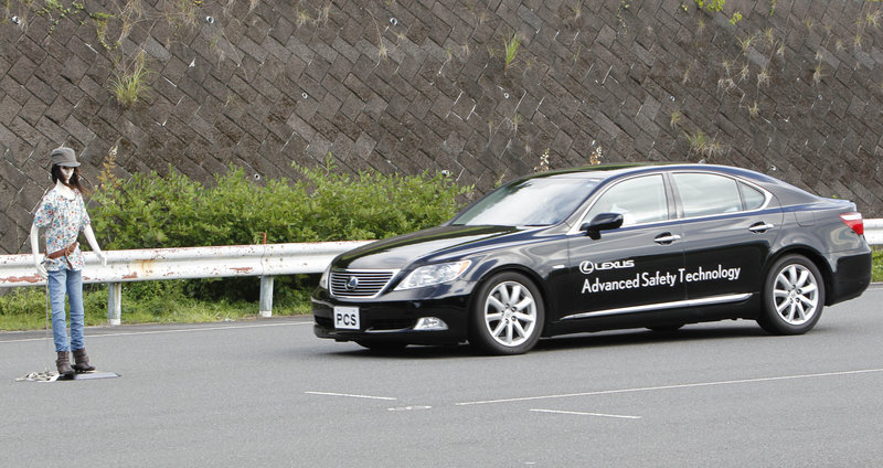 The Associated Press A Toyota stops before hitting a dummy pedestrian during a pre-collison system test demonstration in Suono, Japan. The new system uses cameras and a super sensitive radar called millimeter-wave to detect possible collision situations such as a pedestrian crossing the road.