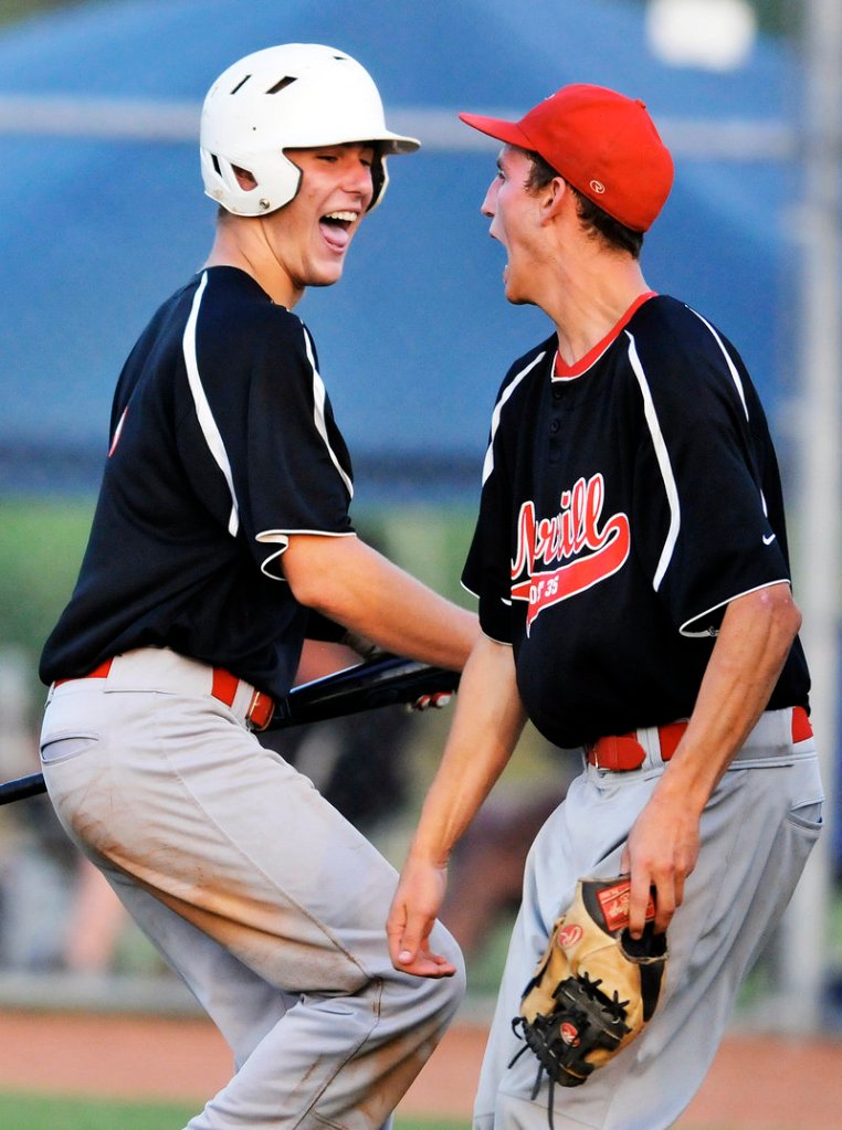 Brendan Horton of Morrill Post, left, celebrates with Paul Reny after scoring the go-ahead run in the eighth inning Thursday in the 10-9 victory against Andrews Post in the Zone 4 championship game.