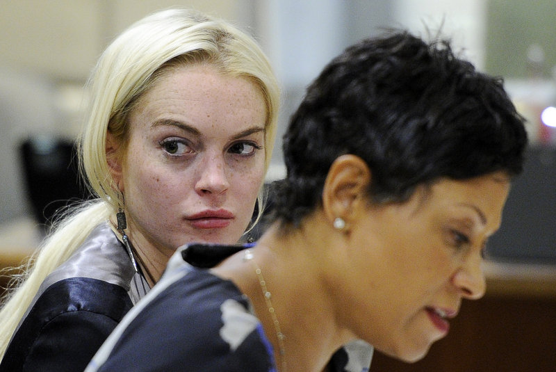 Lindsay Lohan is pictured with her attorney during a hearing on Thursday. A judge said she needs to speed up her community service.