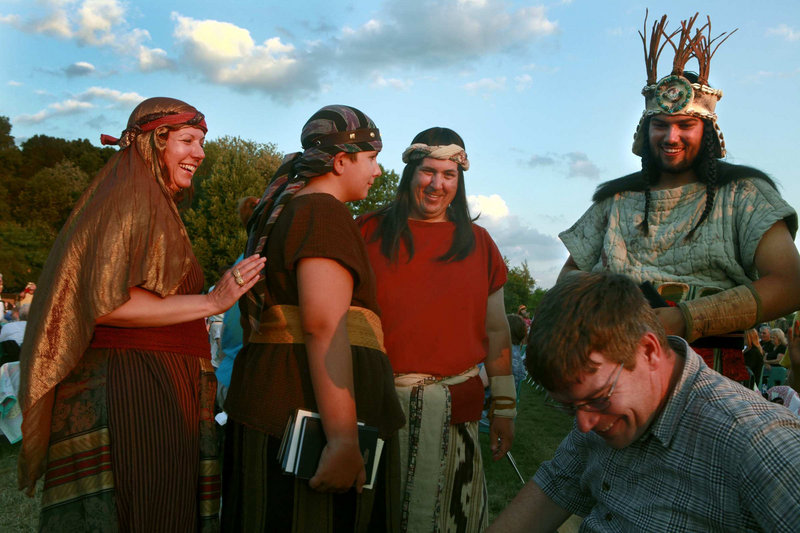 Lee Preston, left, and her husband, Don Preston, in the red shirt, get ready to take part in the Hill Cumorah Pageant, an annual Mormon religious re-enactment of the story of Jesus – and the Book of Mormon – in Palmyra, N.Y. Their son John, second from left, also played a role in this year’s performance, which involved 700 volunteers.