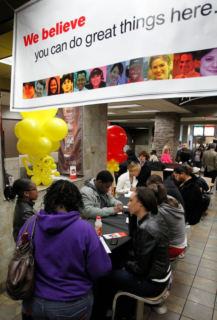 Job seekers fill out applications at a Pittsburgh McDonald’s. The company’s earnings rose 15 percent in the second quarter.