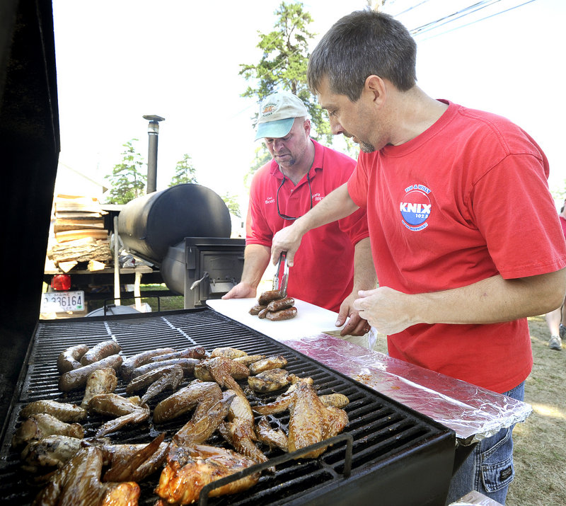 Scott Carter and Brian Douglass from Steep Falls prepare an entry Saturday during the Western Maine BBQ Festival. Forty teams from Maine, New England and as far away as Florida are grilling their best this weekend in pursuit of prizes totaling $12,500 in a variety of categories.