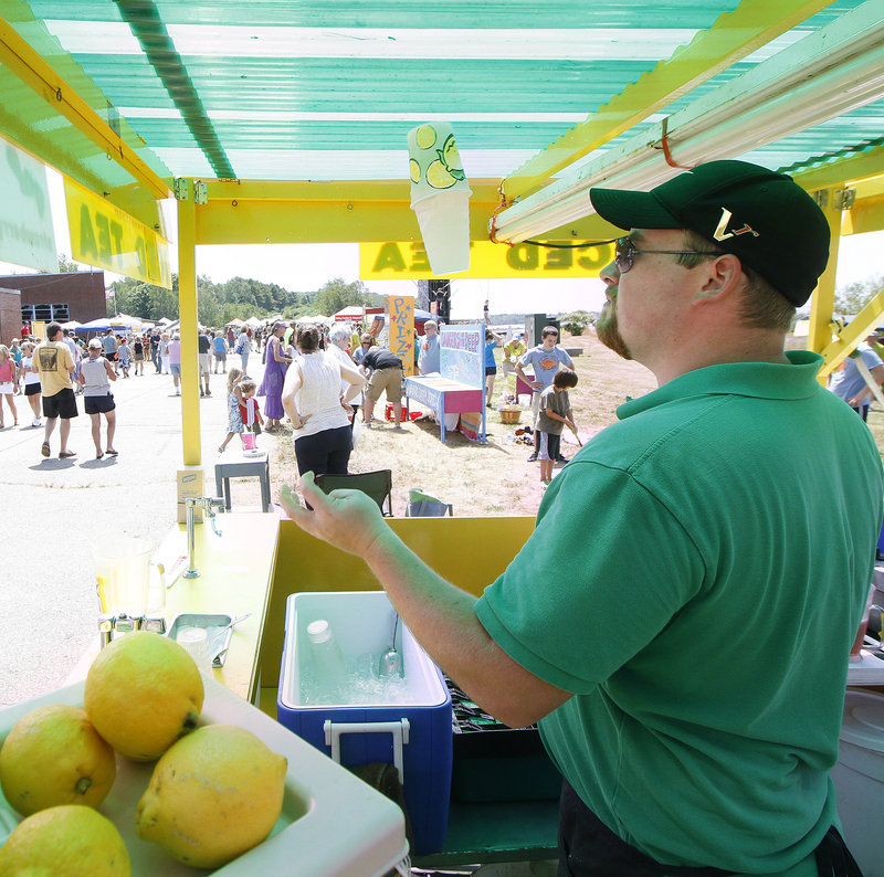 John Frake mixes lemonade for festival-goers.