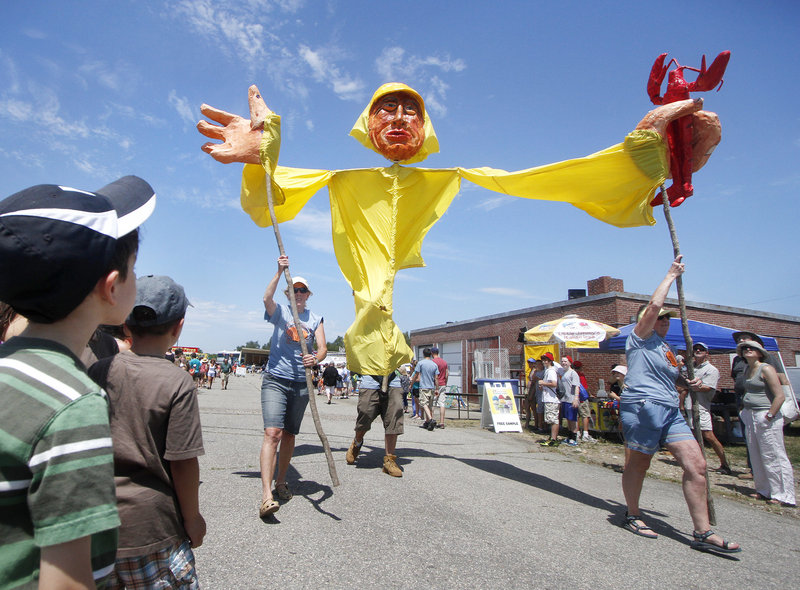 A 15-foot fisherman puppet makes it way down the midway during the parade Saturday at the Harpswell Festival.