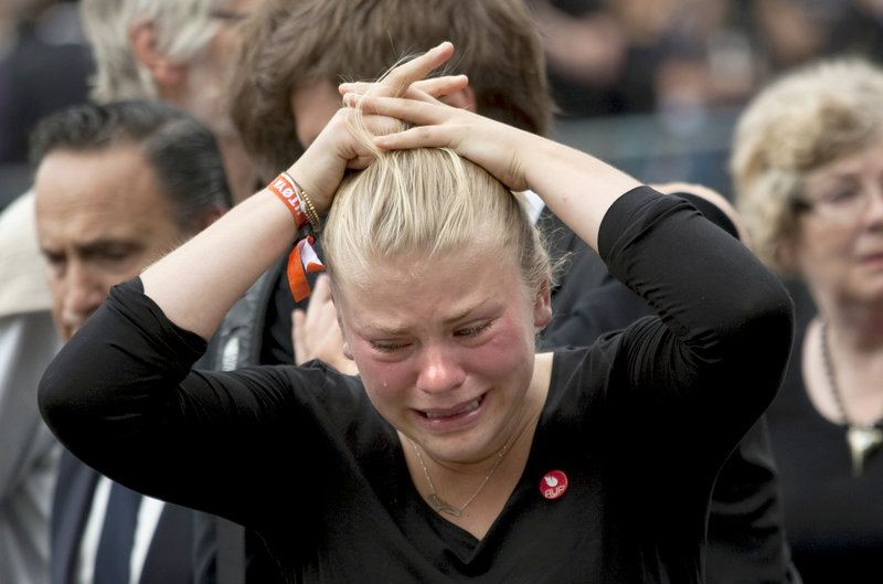 A woman weeps at a memorial service for the victims of Friday's attacks at Oslo Cathedral on Sunday.