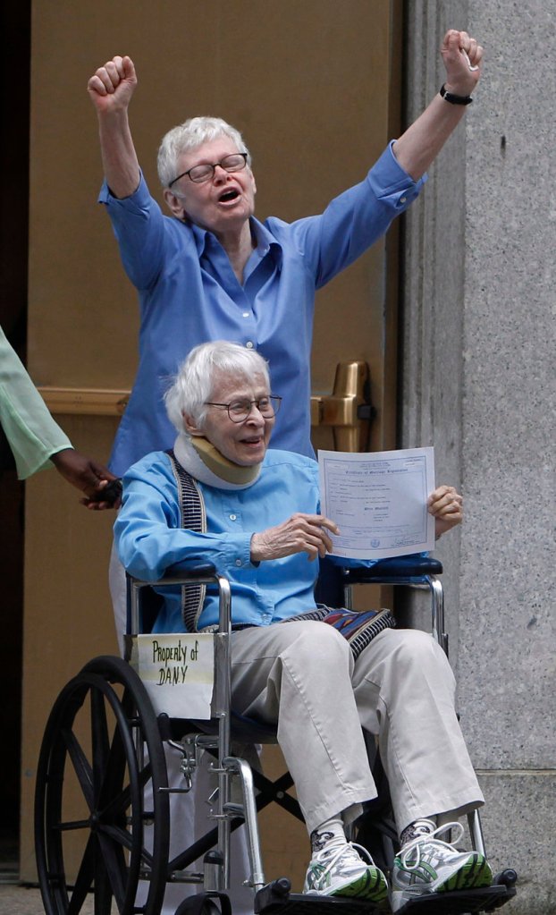 Phyllis Siegel, 77, arms raised, and Connie Kopelov, 85, both of New York, celebrate after becoming the first gay couple to marry in Manhattan, N.Y., on Sunday.