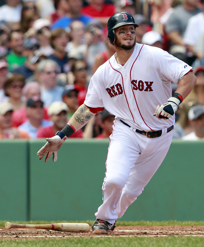 Boston’s Jarrod Saltalamacchia watches his two-run single in the first inning of a 12-8 win over Seattle at Fenway Park on Sunday. The Red Sox catcher had three hits and four RBI.