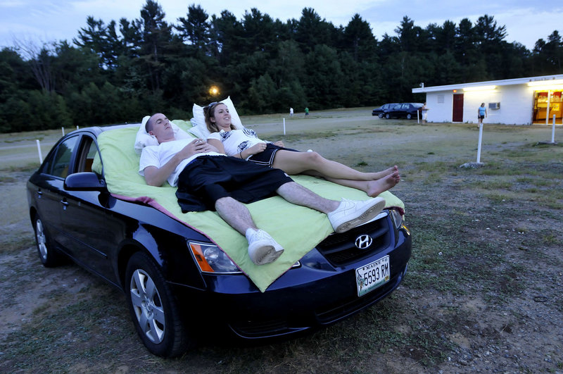 Chris Lamb and Shannon Noyes of Scarborough await the start of the movie at the Saco Drive-In on Route 1 in Saco on Friday.