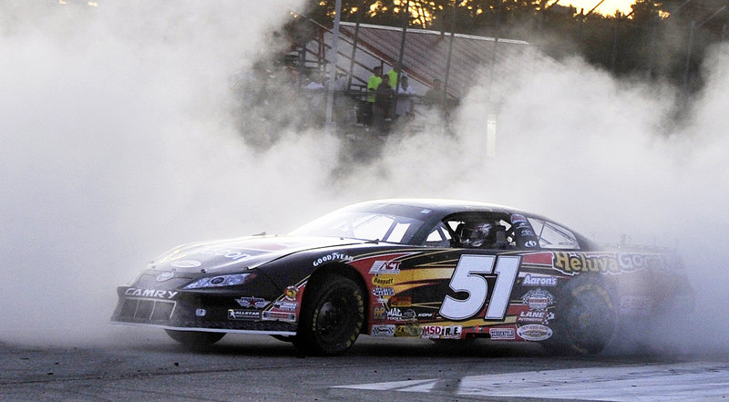 Kyle Busch burns a little rubber in celebration of winning the TD Bank 250 on Sunday night at Oxford Plains Speedway. Busch picked up his first win in the race after unsuccessful bids in 2005 and 2006.