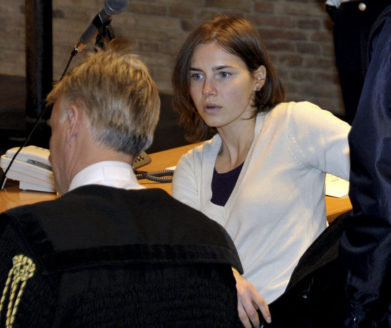Amanda Knox talks with her attorney, Carlo Dalla Vedova, as she arrives to attend a hearing in her appeal trial in Perugia, Italy, on Jan. 22. Last year, the American woman was convicted of the murder of her British roommate, Meredith Kercher, and sentenced to 26 years in prison.