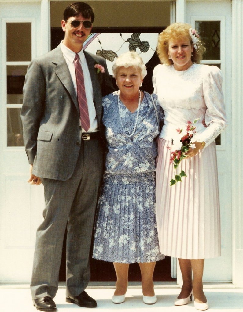 Myrtle Storer, center, poses with newlyweds Penny Cary, her stepniece, and Hosea Carpenter at their wedding on July 22, 1989.